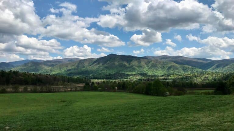 Green fields of Cades Cove below the surrounding Smoky Mountain ridges