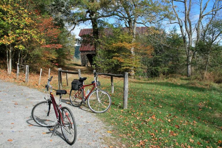 Two bicycles parked beside a gravel lane and historic building